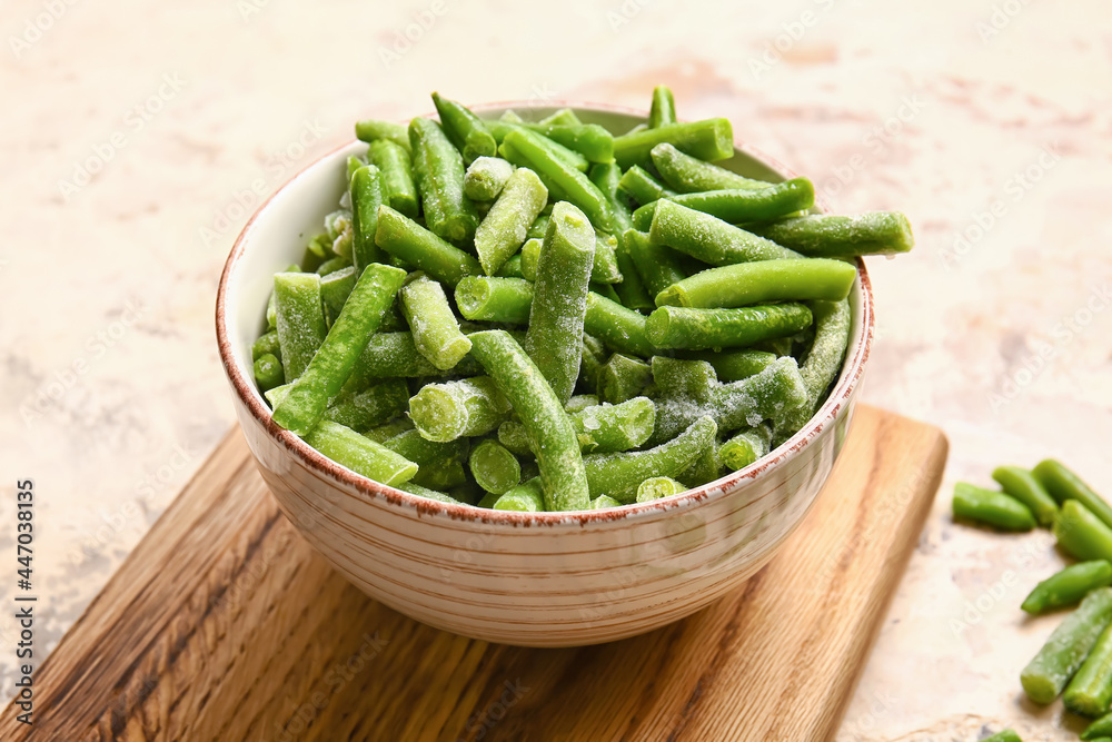 Bowl with frozen green beans on light background Bowl with frozen green beans on light background