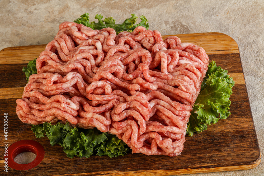 Raw pork minced meat over board Raw pork minced meat over board