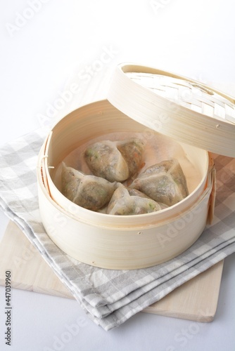 steamed handmade crystal vegetable prawn dumpling in bamboo basket white background dim sum Halal menu