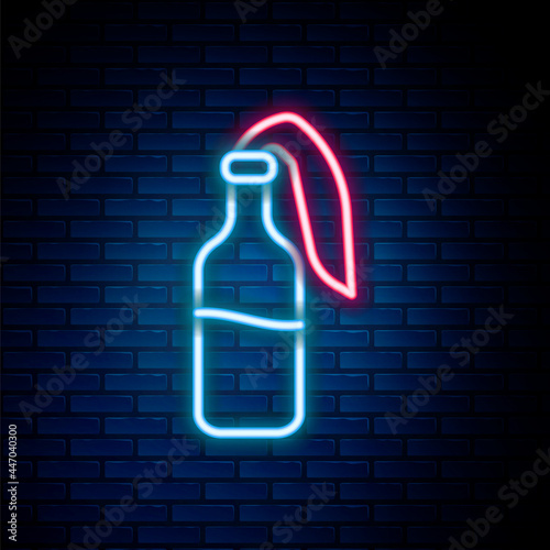 Glowing neon line Cocktail molotov icon isolated on brick wall background. Colorful outline concept. Vector