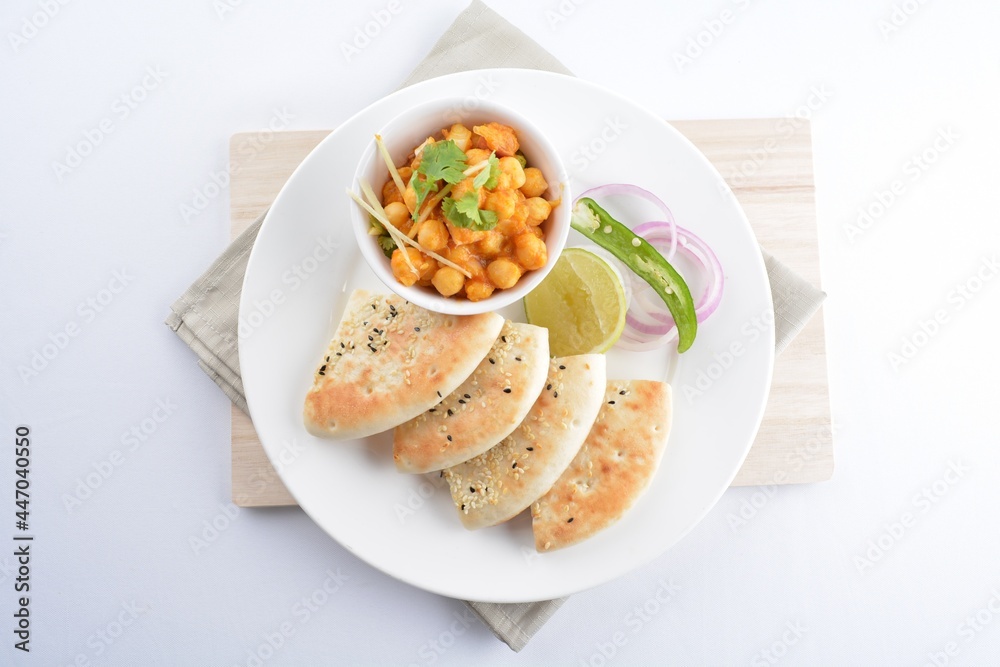 Indian vegetable bean curry with baked naan pizza bread in white background vegan dim sum Halal menu