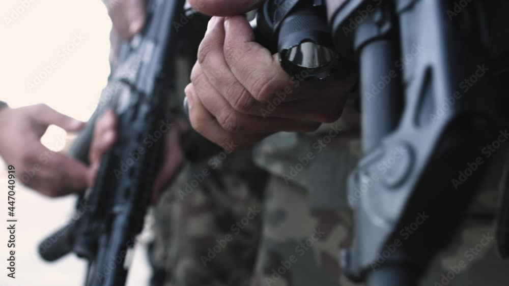 Jericho- May 7, 2017: Male Palestinian national security troop holds tight to his gun. close up. Jericho- May 7, 2017: Male Palestinian national security troop holds tight to his gun. close up.