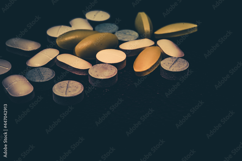 Pharmaceutical medicine pills in both tablets and capsules with the vintage retro picture style. Pharmacy theme and treatment medication as concept Pharmaceutical medicine pills in both tablets and capsules with the vintage retro picture style. Pharmacy theme and treatment medication as concept