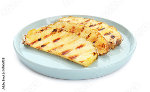 Plate with grilled pineapple slices on white background