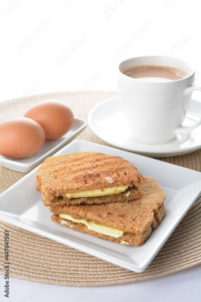 butter toast bread set with half boiled egg and coffee or tea in white background asian halal menu butter toast bread set with half boiled egg and coffee or tea in white background asian halal menu
