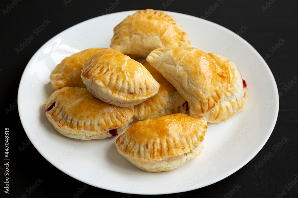 Homemade Cherry Hand Pies on a plate, low angle view. Homemade Cherry Hand Pies on a plate, low angle view.