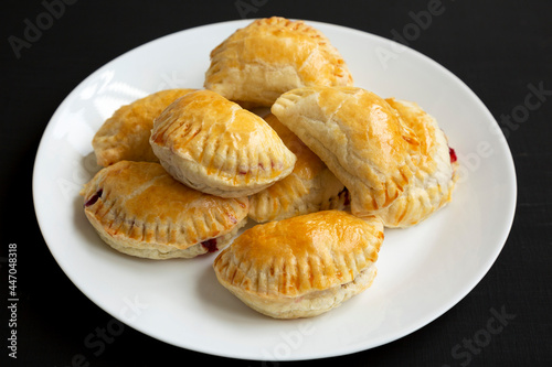 Homemade Cherry Hand Pies on a plate, low angle view.