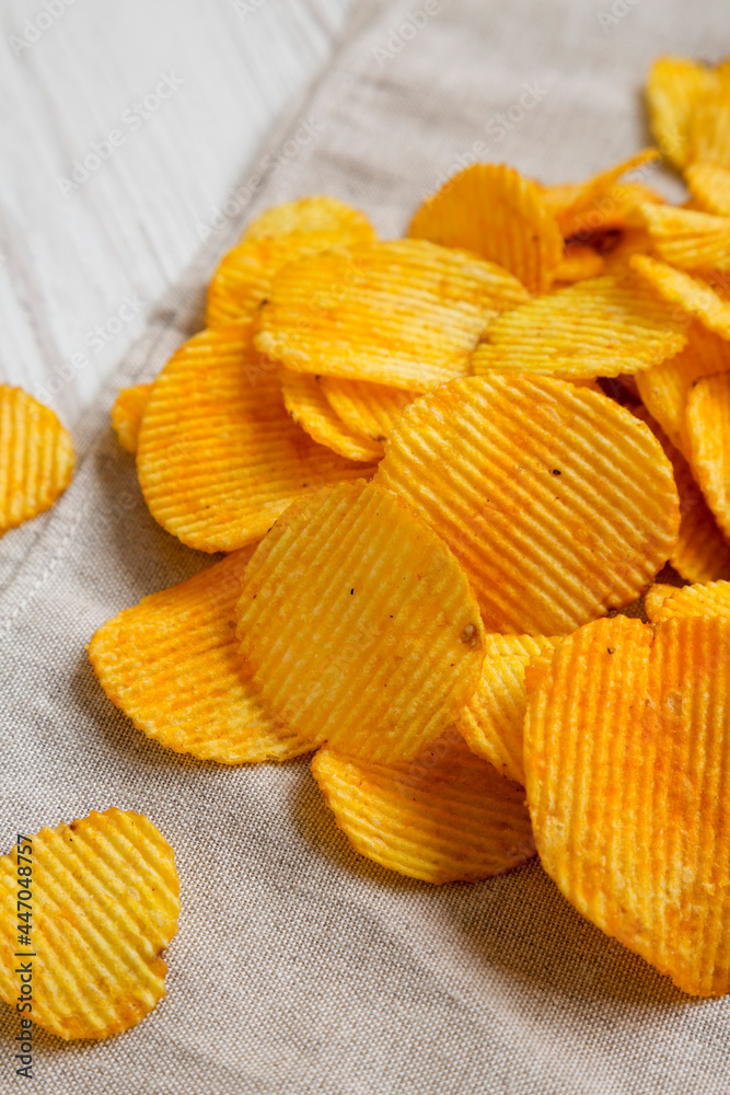 Ruffled Cheese Potato Chips, side view. Close-up. Ruffled Cheese Potato Chips, side view. Close-up.