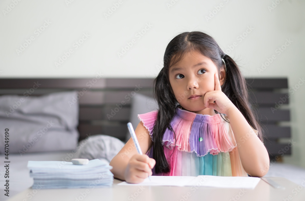 asian child student back to school or kid girl smile write or draw on book with doing homework to new idea think and finger point up or people learn from home in bedroom and study online to book stack asian child student back to school or kid girl smile write or draw on book with doing homework to new idea think and finger point up or people learn from home in bedroom and study online to book stack