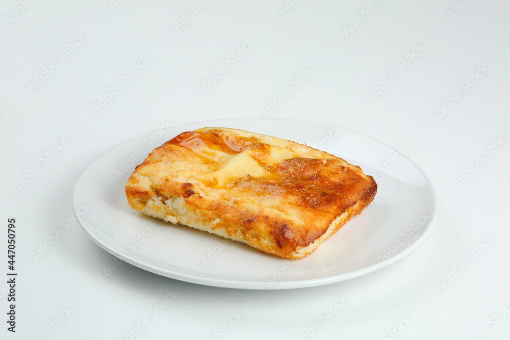 cottage cheese casserole in white plate closeup with copy space. cottage cheese casserole isolated om white