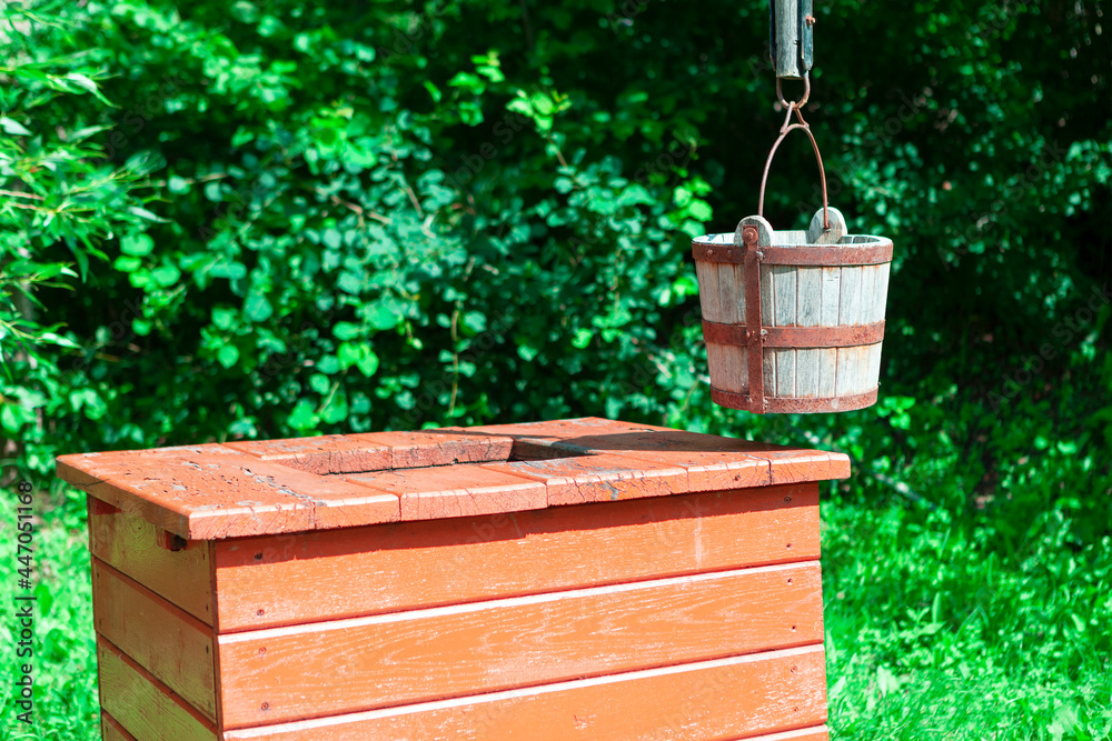 Well with wooden bucket . Drinking water source Well with wooden bucket . Drinking water source
