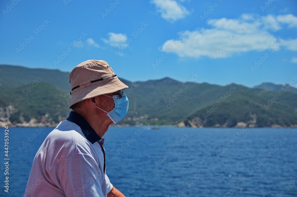 Senior man with medicine mask on the boat