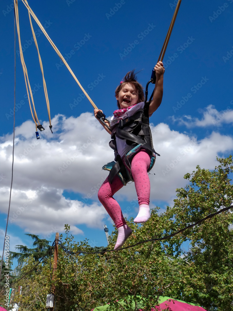 Little girl having fun on a fairground ride