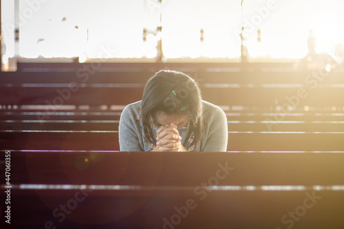 Asian woman in Thailand sitting in a church praying
