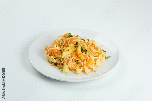 cabbage salad with apple and carrot isolated on white. fresh vitamin salad in plate