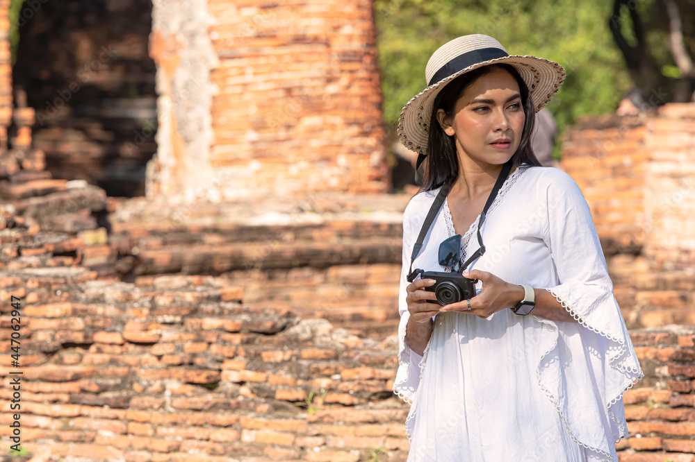 Asian female tourists taking pictures at Wat Phra Si Sanphet, Phra Nakhon Si Ayutthaya, Thailand