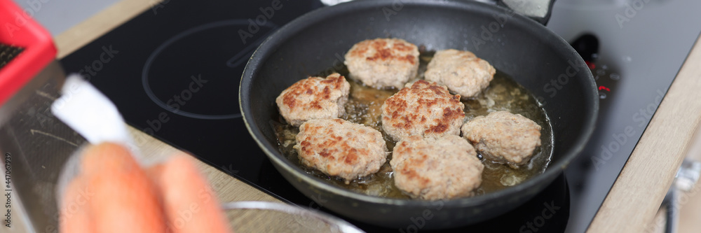 In kitchen, cutlets are fried in frying pan In kitchen, cutlets are fried in frying pan