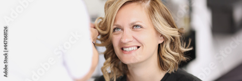 Portrait of smiling woman who has her hair done from curls