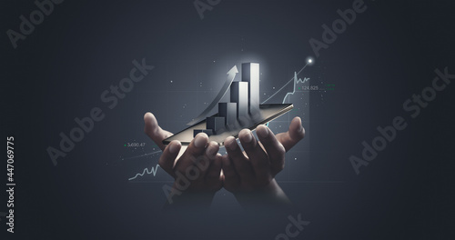 Businessman holding stock tablet and market economy graph statistic showing growth of profit analyzing financial exchange on increase digital money background with trade chart finance data concept.