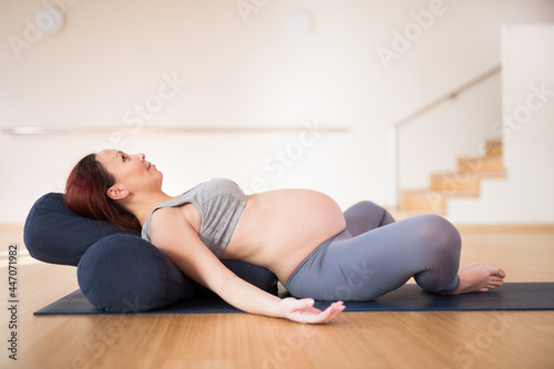pregnant woman is engaged in yoga. Reclined Bound Angle Pose or Supta Baddha Konasana