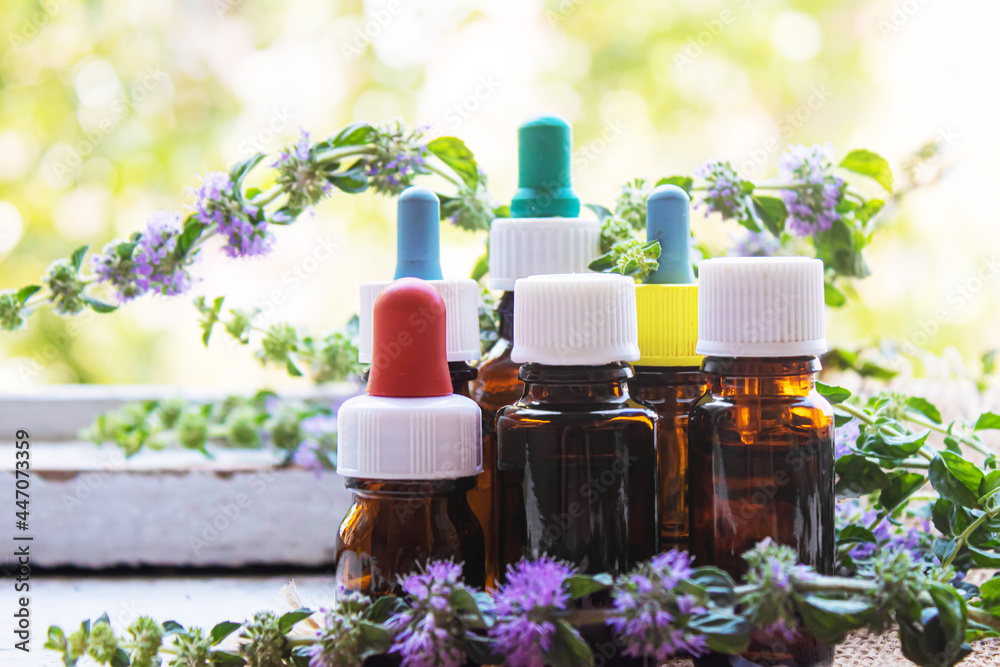 Thyme essential oil in a small bottle. selective focus . Thyme essential oil in a small bottle. selective focus .