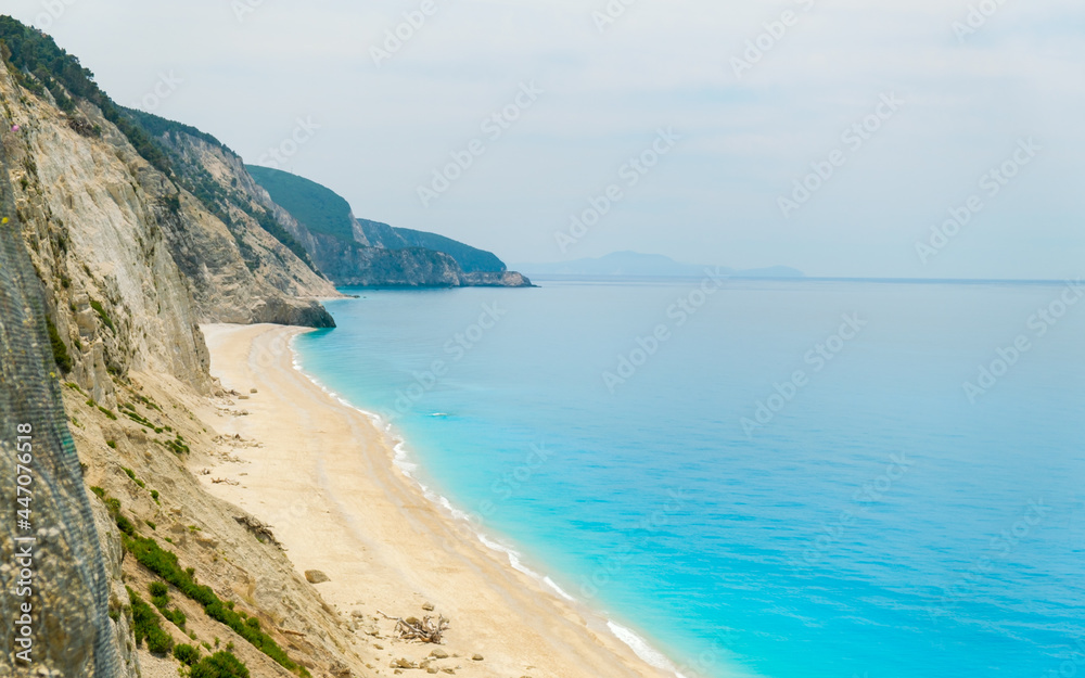 View from above on beautiful coast with white sand and aqua blue water and steep cliffs View from above on beautiful coast with white sand and aqua blue water and steep cliffs