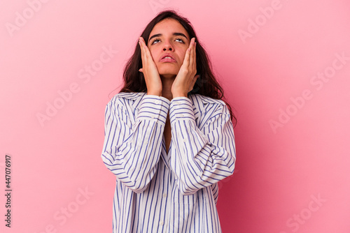 Young caucasian woman isolated on pink background whining and crying disconsolately.