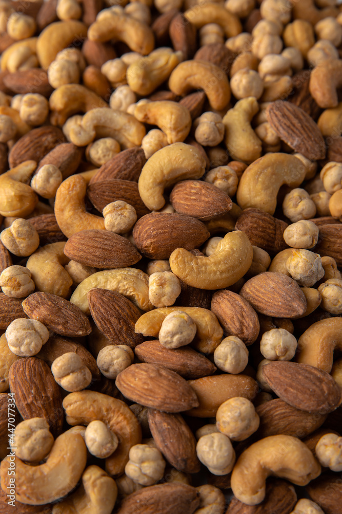 A mixture of cashews, almonds and chickpeas. Roasted nuts with salt. High protein product. Healthy dietary nutritional product. Vegetarian balanced meal. Selective focus A mixture of cashews, almonds and chickpeas. Roasted nuts with salt. High protein product. Healthy dietary nutritional product. Vegetarian balanced meal. Selective focus