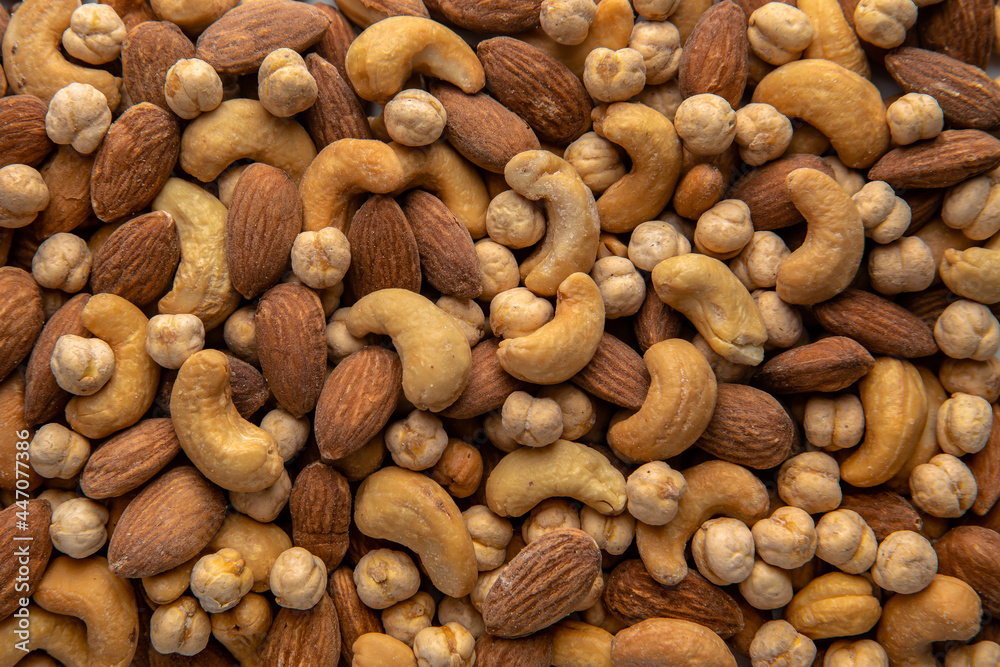 A mixture of cashews, almonds and chickpeas. Roasted nuts with salt. High protein product. Healthy dietary nutritional product. Vegetarian balanced meal. Selective focus A mixture of cashews, almonds and chickpeas. Roasted nuts with salt. High protein product. Healthy dietary nutritional product. Vegetarian balanced meal. Selective focus