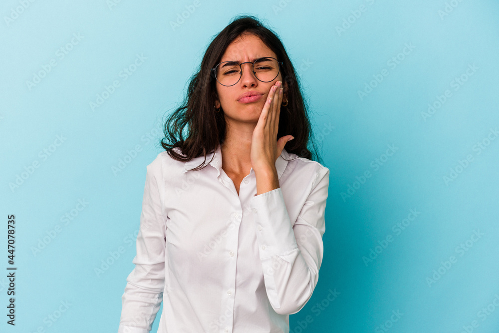 Young caucasian woman isolated on blue background having a strong teeth pain, molar ache. Young caucasian woman isolated on blue background having a strong teeth pain, molar ache.