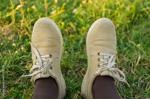 Pair of cream shoes on the grass background