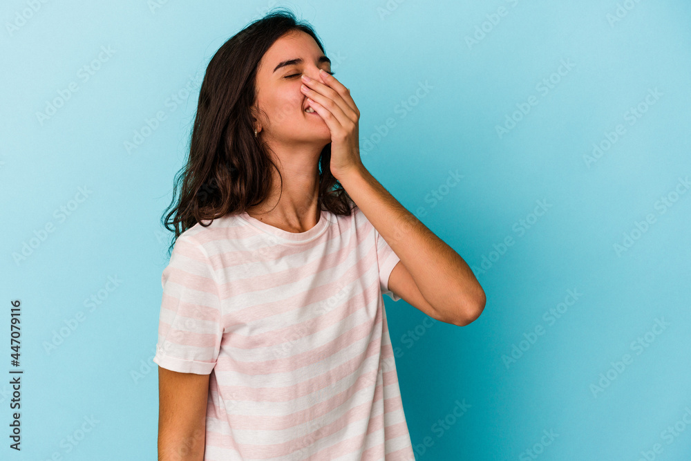 Young caucasian woman isolated on blue background laughing happy, carefree, natural emotion. Young caucasian woman isolated on blue background laughing happy, carefree, natural emotion.