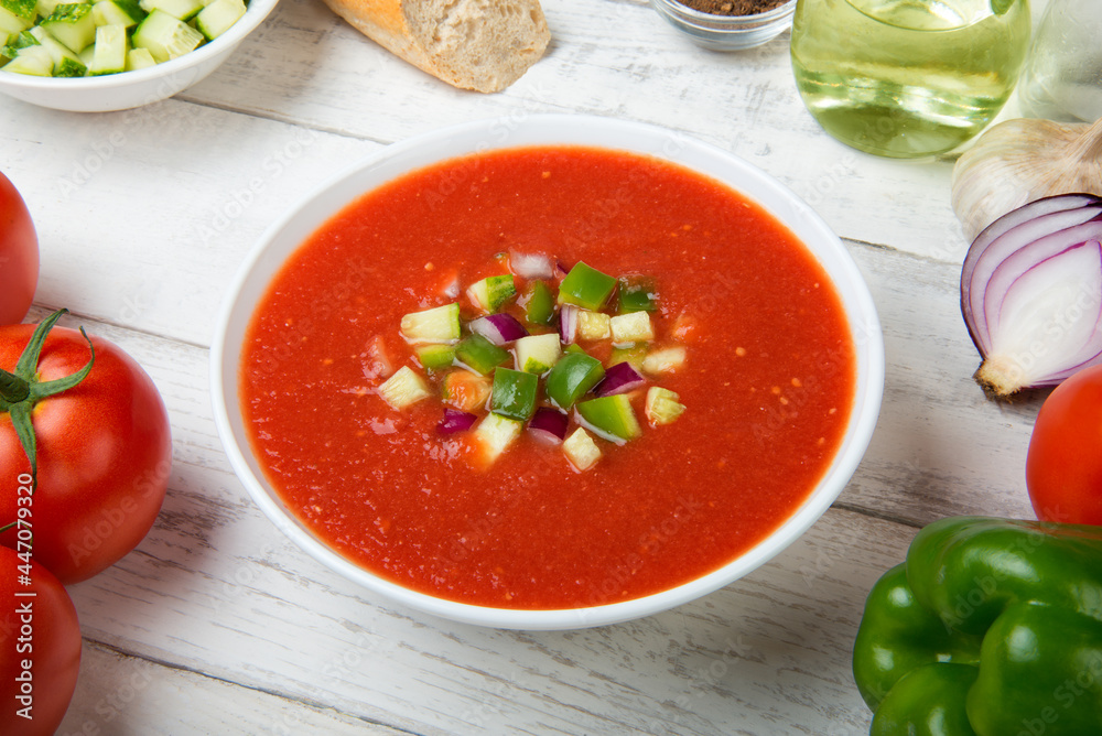 Gazpacho. Traditional Spanish tomato soup with fresh tomatoes, cucumber, bell pepper on a white rustic wooden table. Gazpacho. Traditional Spanish tomato soup with fresh tomatoes, cucumber, bell pepper on a white rustic wooden table.