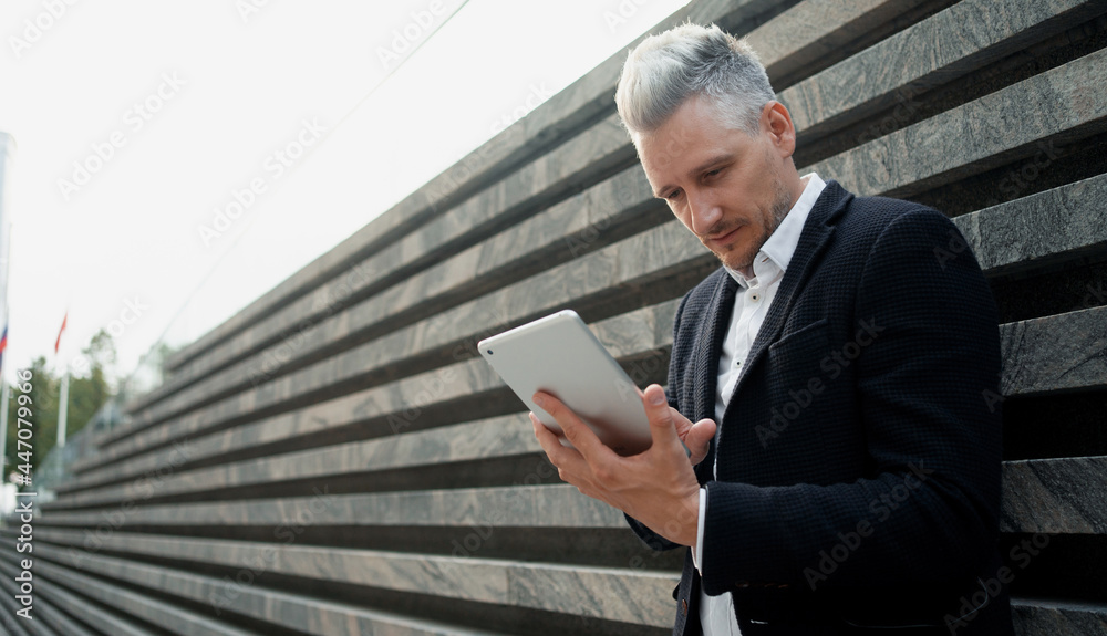 Online shopping in a mobile application. Manager to surf the Internet in the device. The economist counts the results of his work in the new project according to the table.