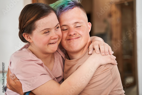 Girl with special needs embracing tight her boyfriend with colored hair