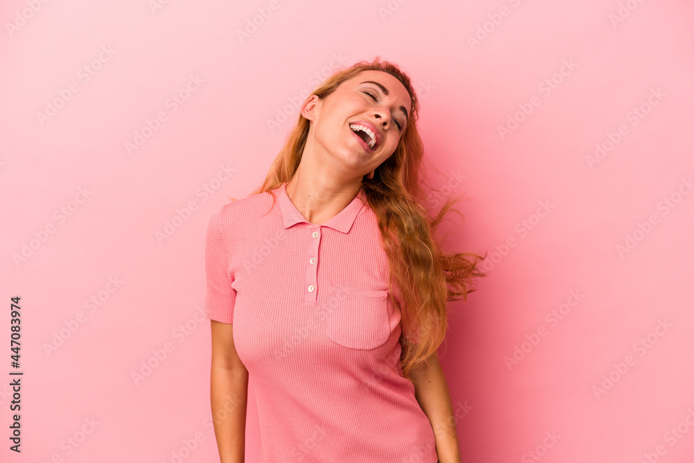 Caucasian blonde woman isolated on pink background dancing and having fun. Caucasian blonde woman isolated on pink background dancing and having fun.