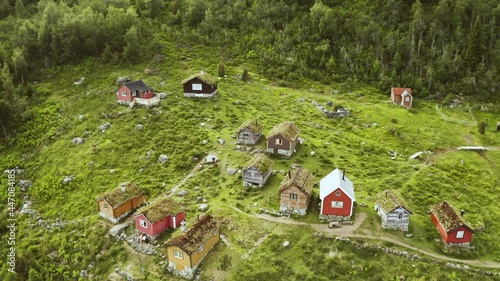 Rustic Cottages Situated At Lush Green Mountain Hillside In Rakssetra, Norway. - Aerial Drone Shot photo