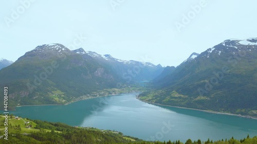 Peaceful Scenery Of Lake And Green Mountains In Rakssetra, Loen, Norway - aerial pullback photo