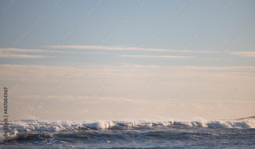 Beautiful sunset with crashing ocean waves in the foreground. Beautiful sunset with crashing ocean waves in the foreground.