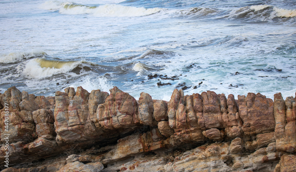 Texture background of waves in the background with rocks in the foreground. Texture background of waves in the background with rocks in the foreground.