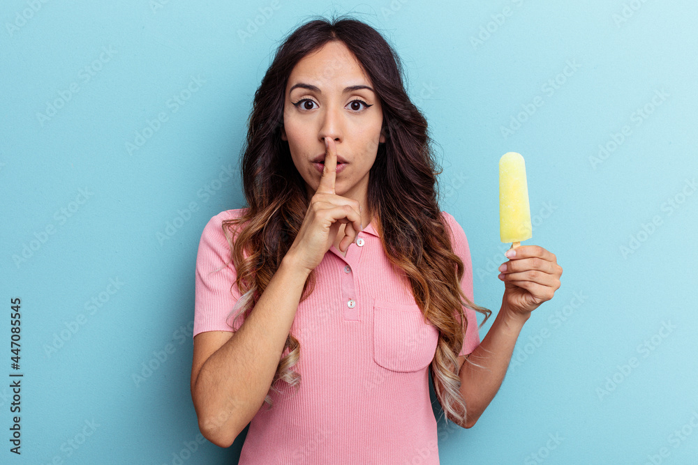 Young latin woman holding ice cream isolated on blue background keeping a secret or asking for silence. Young latin woman holding ice cream isolated on blue background keeping a secret or asking for silence.