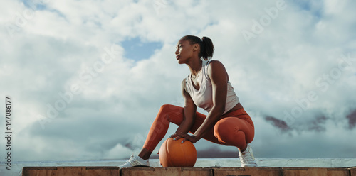 Fototapeta Naklejka Na Ścianę i Meble -  Woman relaxing after exercise on rooftop