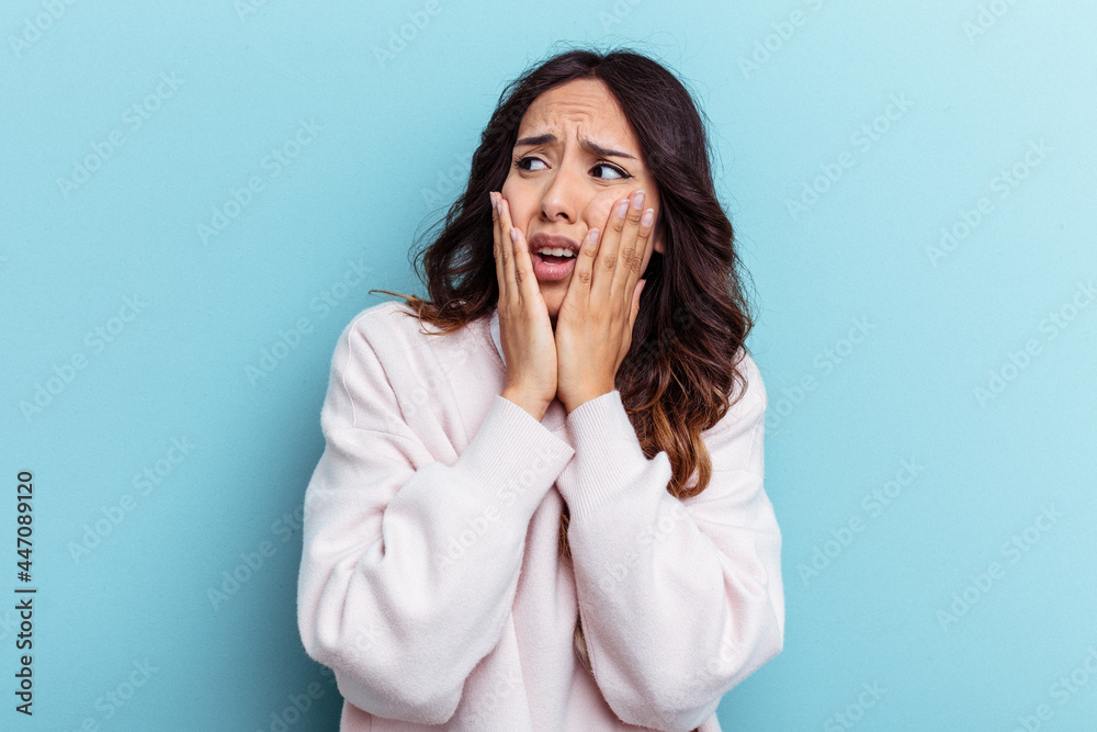 Young mexican woman isolated on blue background scared and afraid. Young mexican woman isolated on blue background scared and afraid.