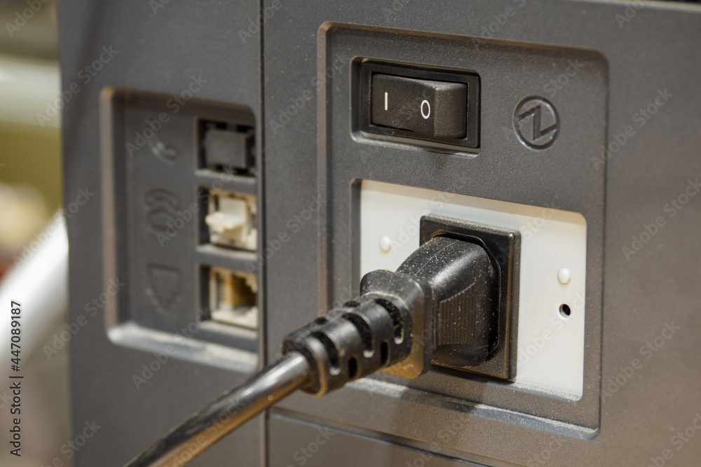 Power cord plugged into a power outlet.