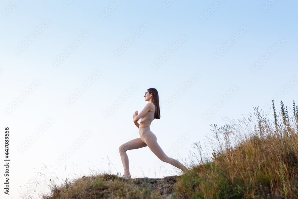 young woman doing gymnastic yoga alone with herself young woman doing gymnastic yoga alone with herself