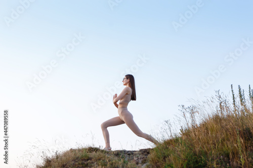 young woman doing gymnastic yoga alone with herself