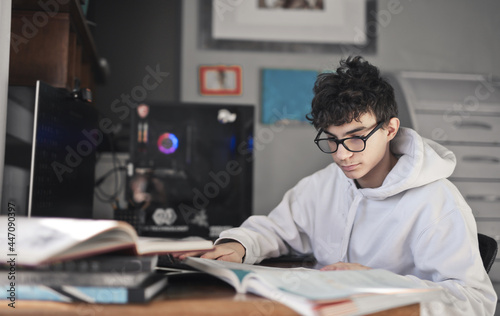 young boy studies in his bedroom