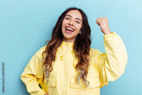 Bild auf Leinwand Young mexican woman isolated on blue background cheering carefree and excited