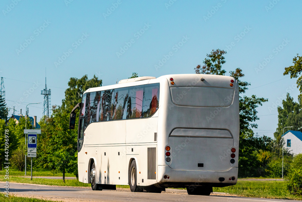 Rear view of white bus traveling on the road