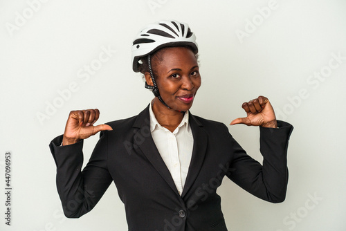 Young business african american woman wearing a bike helmet isolated on white background feels proud and self confident, example to follow. © Asier